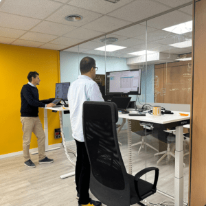 Code10 consultants collaborating in the office using height-adjustable workstations, whiteboard planning and SAP development tools during an enterprise integration project.