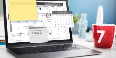 Laptop displaying a digital calendar with tax reporting deadlines and compliance planning reminders.