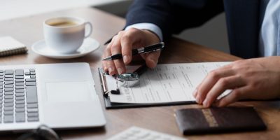 Business professional reviewing payment and reporting documents for CESOP compliance in France.