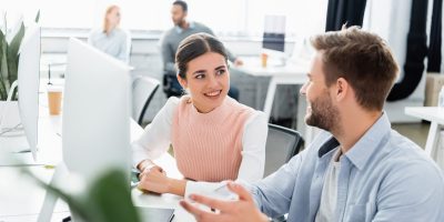 Stock image showing professionals collaborating in a modern office environment. Ideal for the About Code10 section, highlighting teamwork, company culture, and a collaborative way of working.