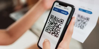 User scanning electronic invoice QR code on smartphone for digital payment processing