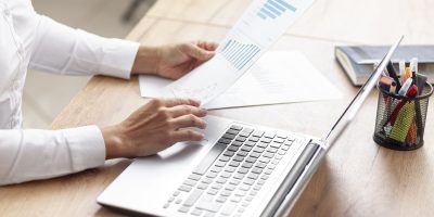 Professional reviewing financial reports and accounting records for FEC audit file compliance in France.