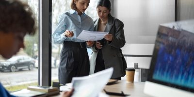 Two professionals reviewing financial documents together representing SAF-T compliance and reporting processes in Poland