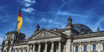 German parliament building with national flag representing compliance and regulatory environment in Germany