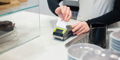 Person printing receipt representing electronic invoicing and FacturaE compliance in Spain