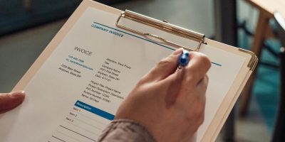 Person reviewing invoice representing TicketBAI tax compliance in the Basque Country