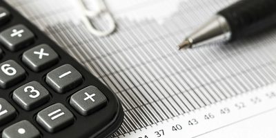 Calculator and pen on financial document representing VeriFactu tax compliance in Spain