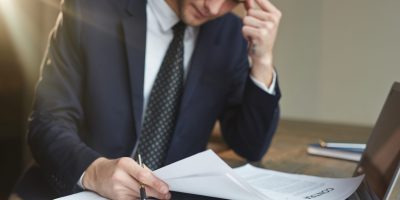 Professional reviewing accounting documents and financial records for FEC compliance and tax audit preparation in France.