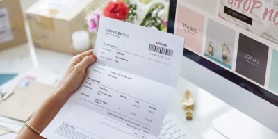 Digital invoice being reviewed alongside an online platform representing B2B e-invoicing in Germany