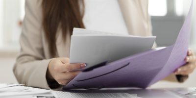 Professional reviewing business documents and compliance records for French tax reporting and regulatory obligations.